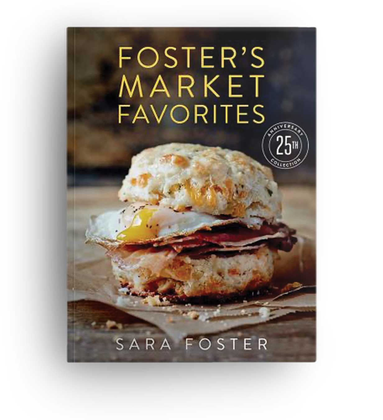 Book titled 'Foster's Market Favorites' showing a sandwich with a biscuit, fried egg, and sliced meat on a wooden surface.